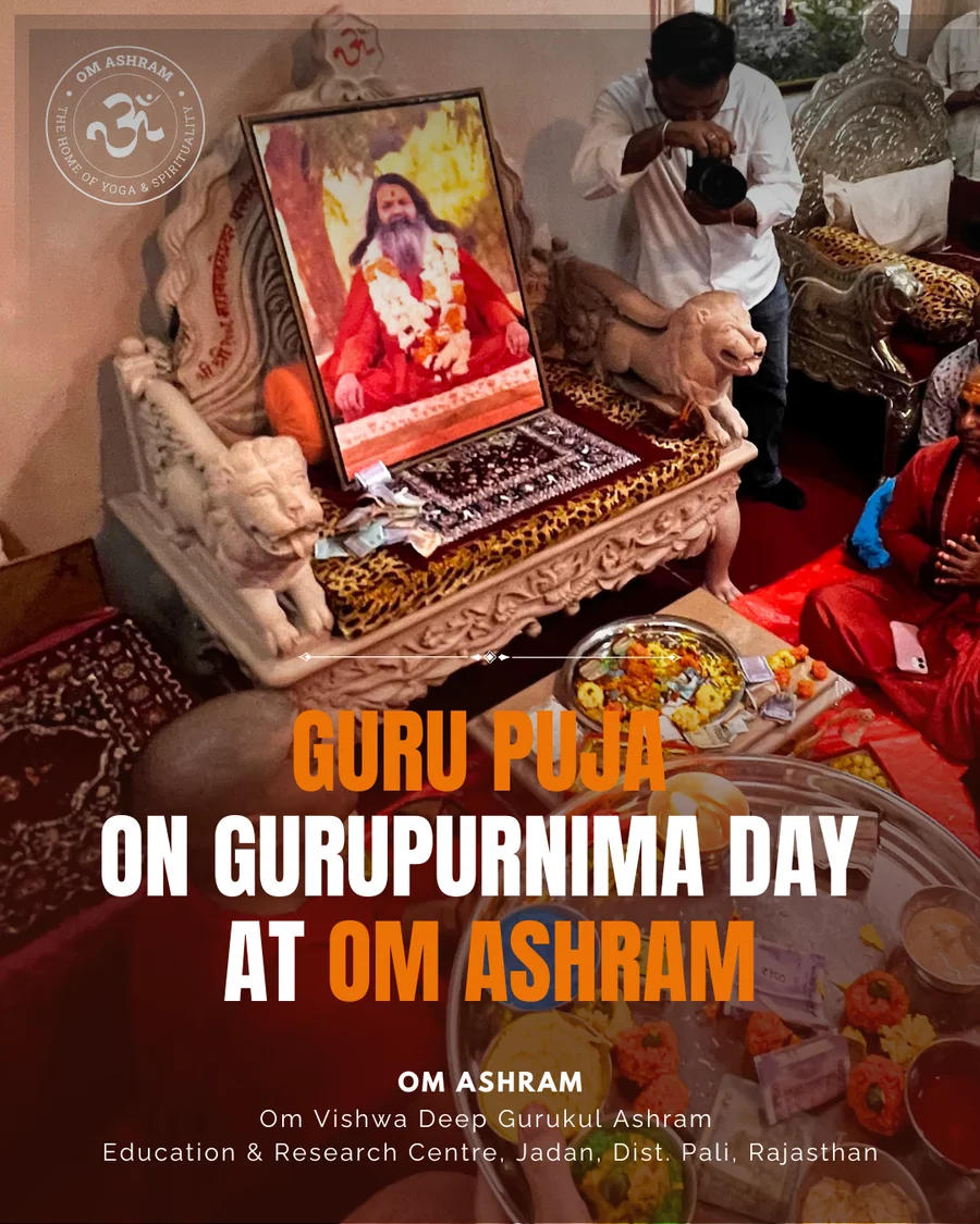 A traditional puja thali with flowers and lamps before the gadi of Gurudev.